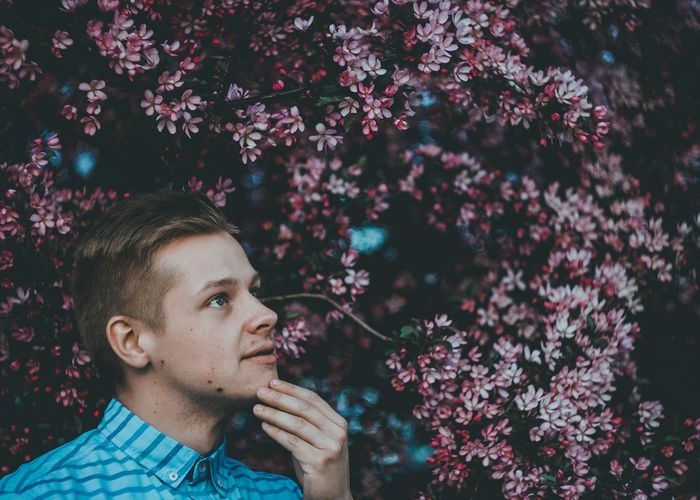 Person meditating peacefully outdoors, surrounded by nature.